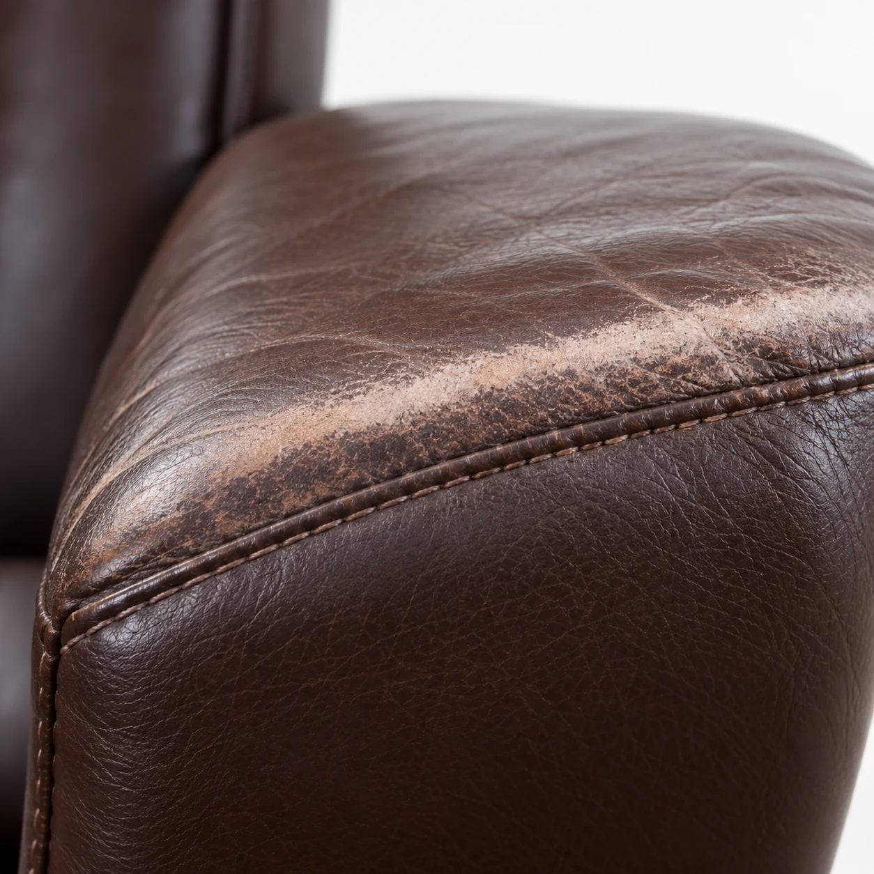 Brown leather office chair seat edge after colour work
