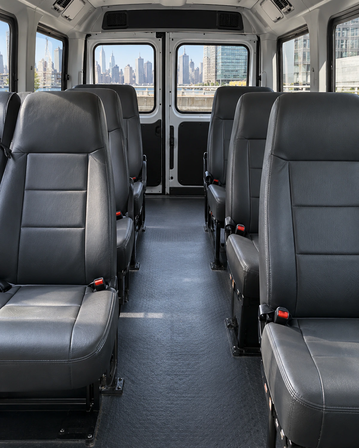 Two rows of vinyl seats inside a passenger van