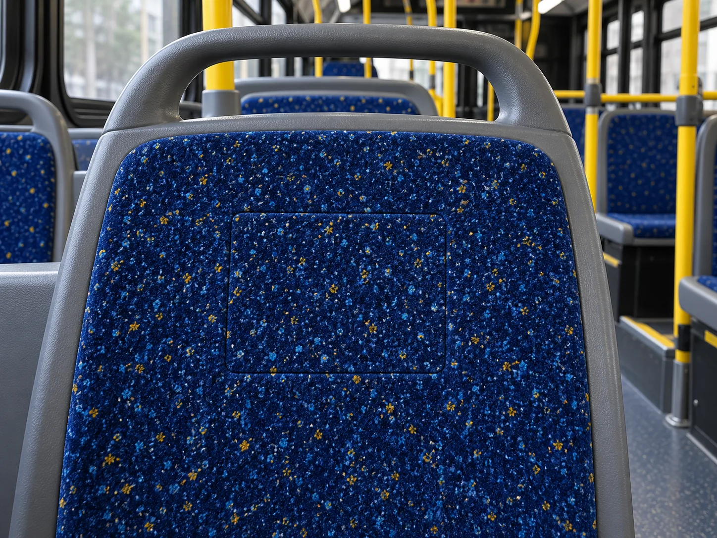 A finished patch in a moquette seat back where the pattern runs straight through