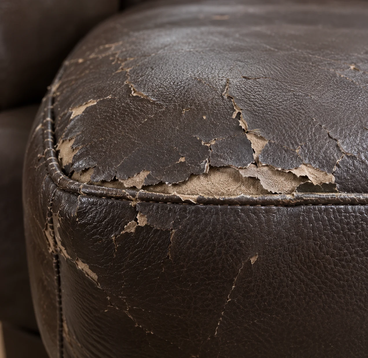 Peeling topcoat on a leather ottoman