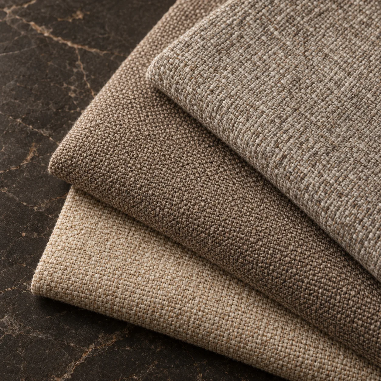 Folded swatches of gray performance upholstery fabric