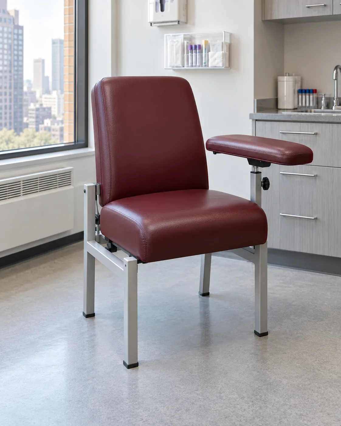 A burgundy vinyl phlebotomy chair with a padded arm board