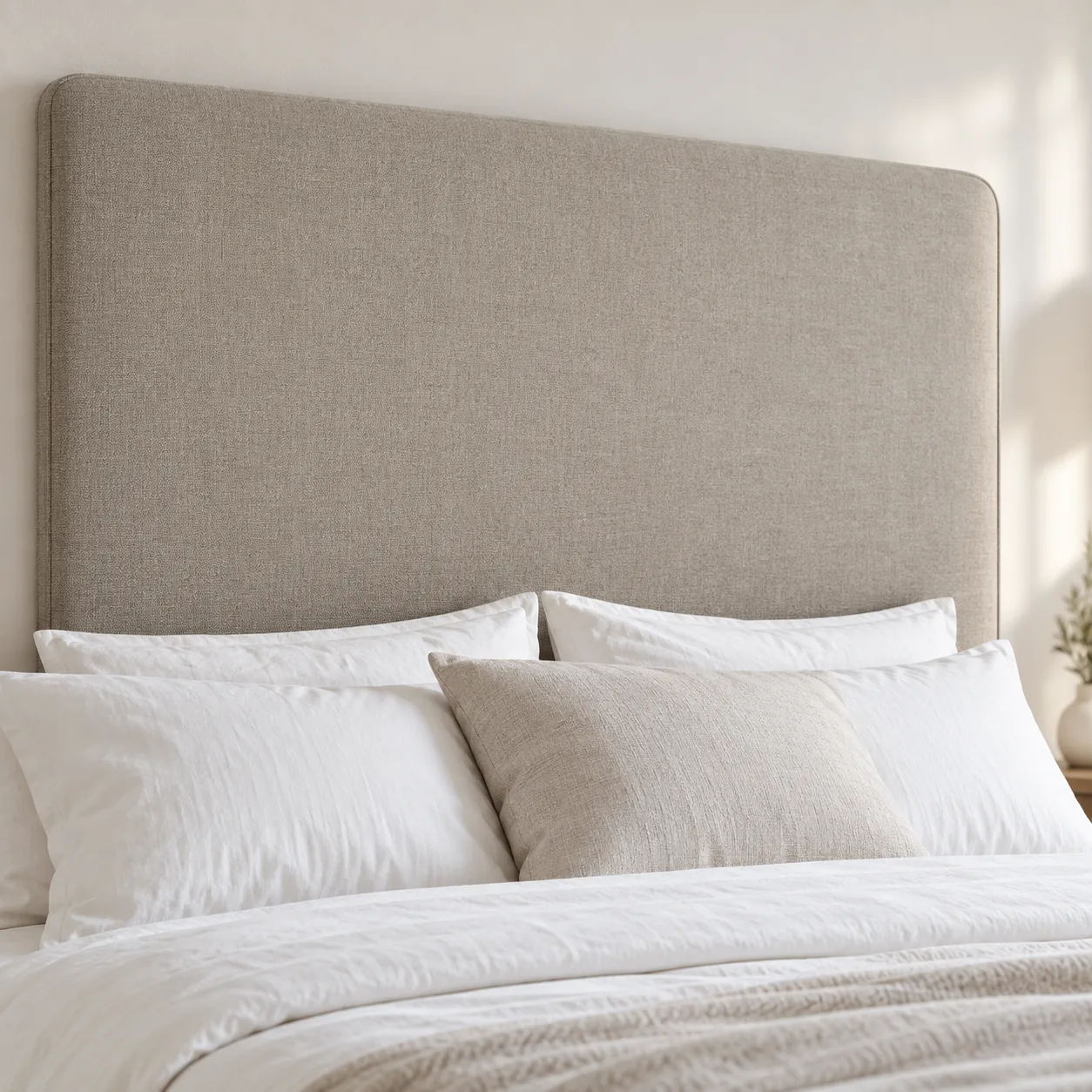 Plain slab headboard in oatmeal linen with softly rounded corners