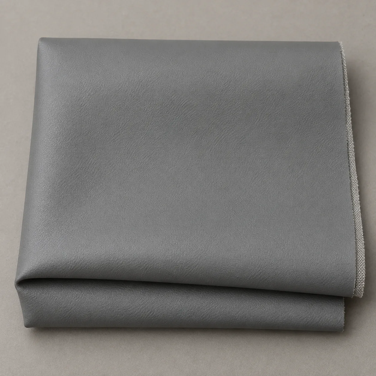 A swatch of grey polyurethane-coated upholstery fabric