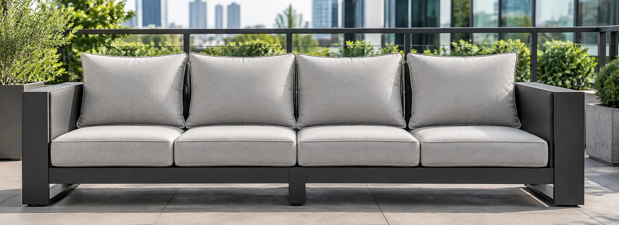 Outdoor terrace sofa with gray cushions in a residential common area