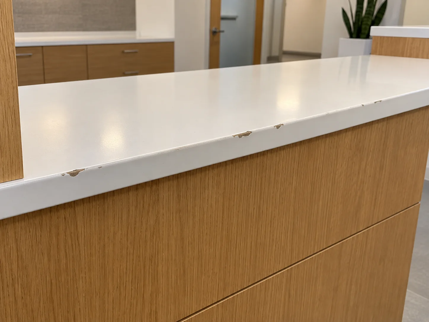 Chipped edge on a wood reception desk