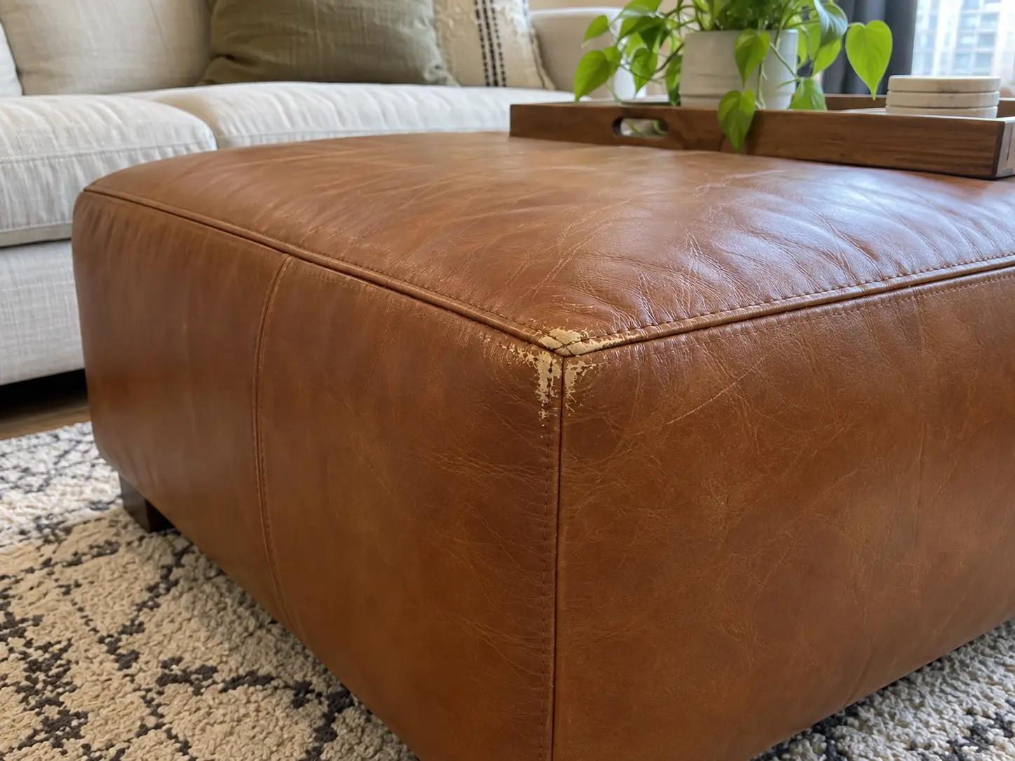 Scuffed cognac ottoman corner