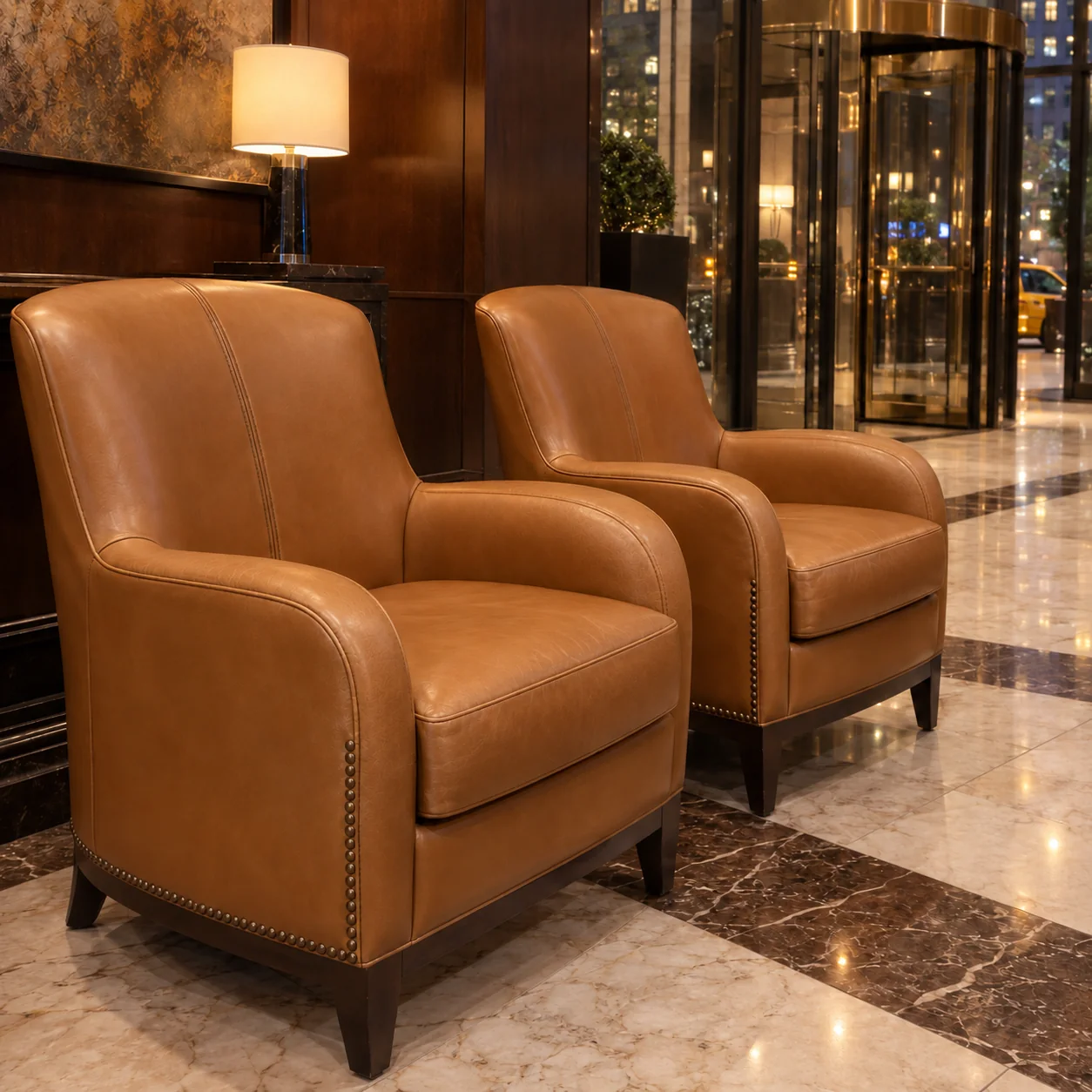 The restored pair of leather lounge chairs back in place by a hotel entrance