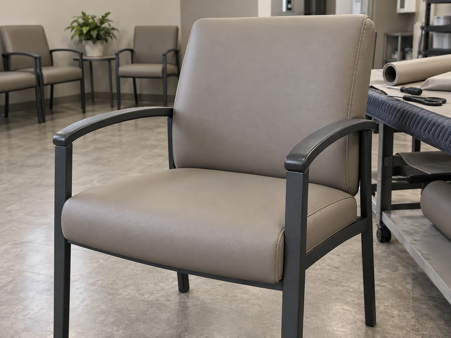 A reupholstered taupe waiting room chair in the workshop