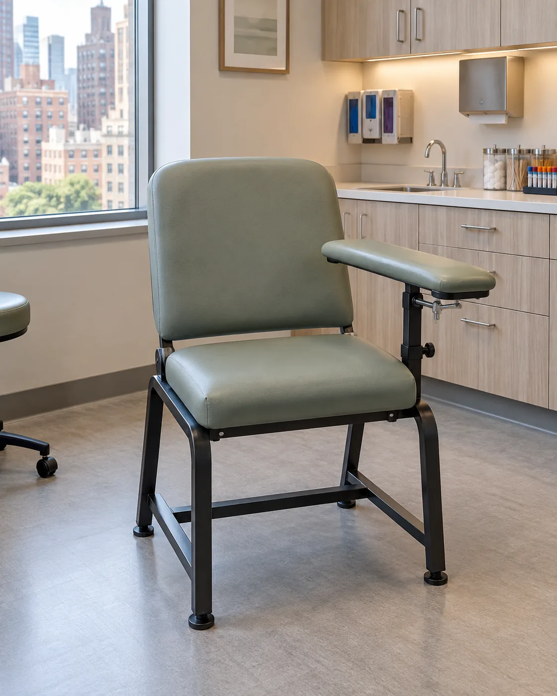 A sage green blood draw chair with a padded swing armrest
