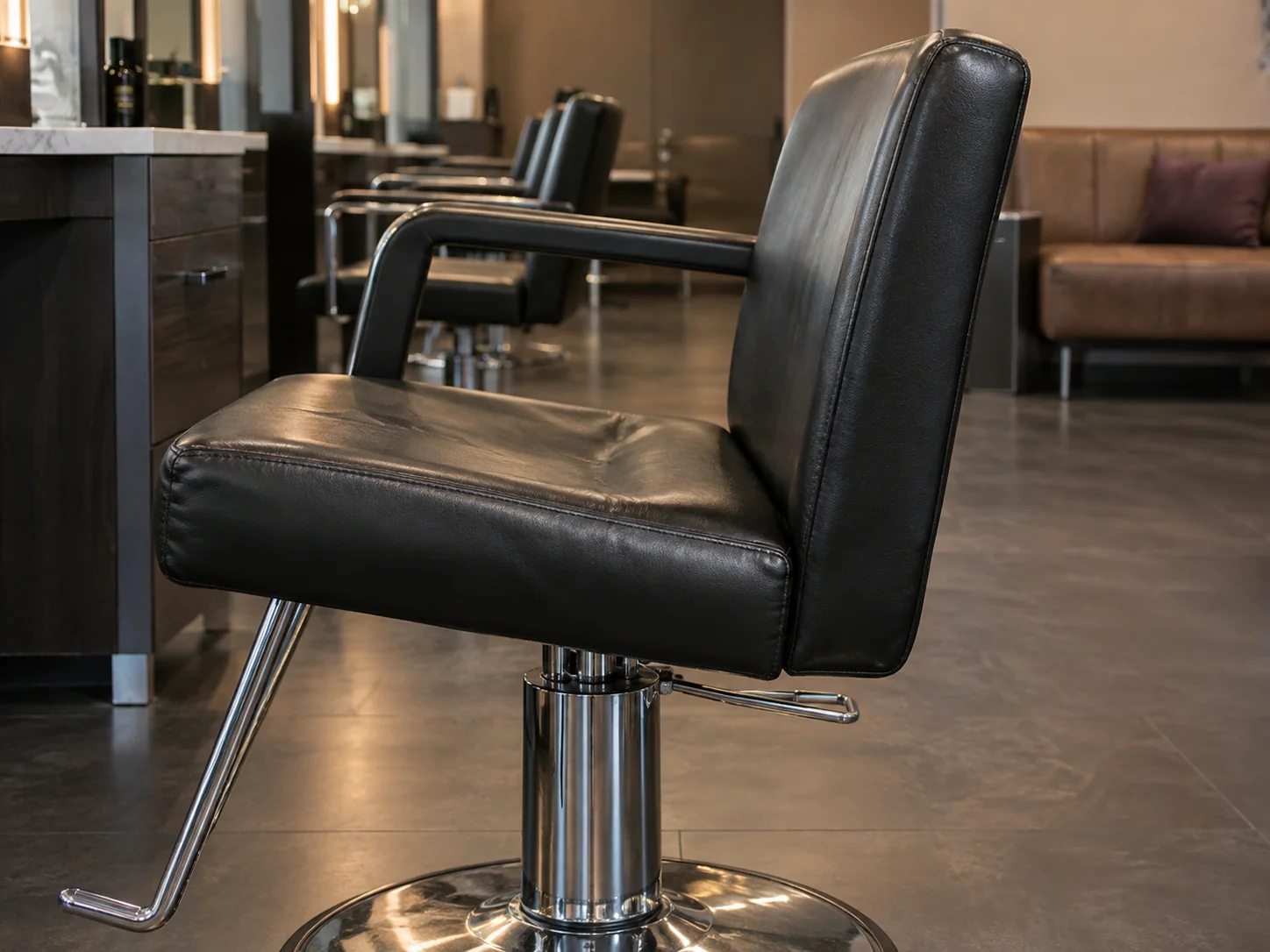 A salon chair with a sagging, flattened seat cushion