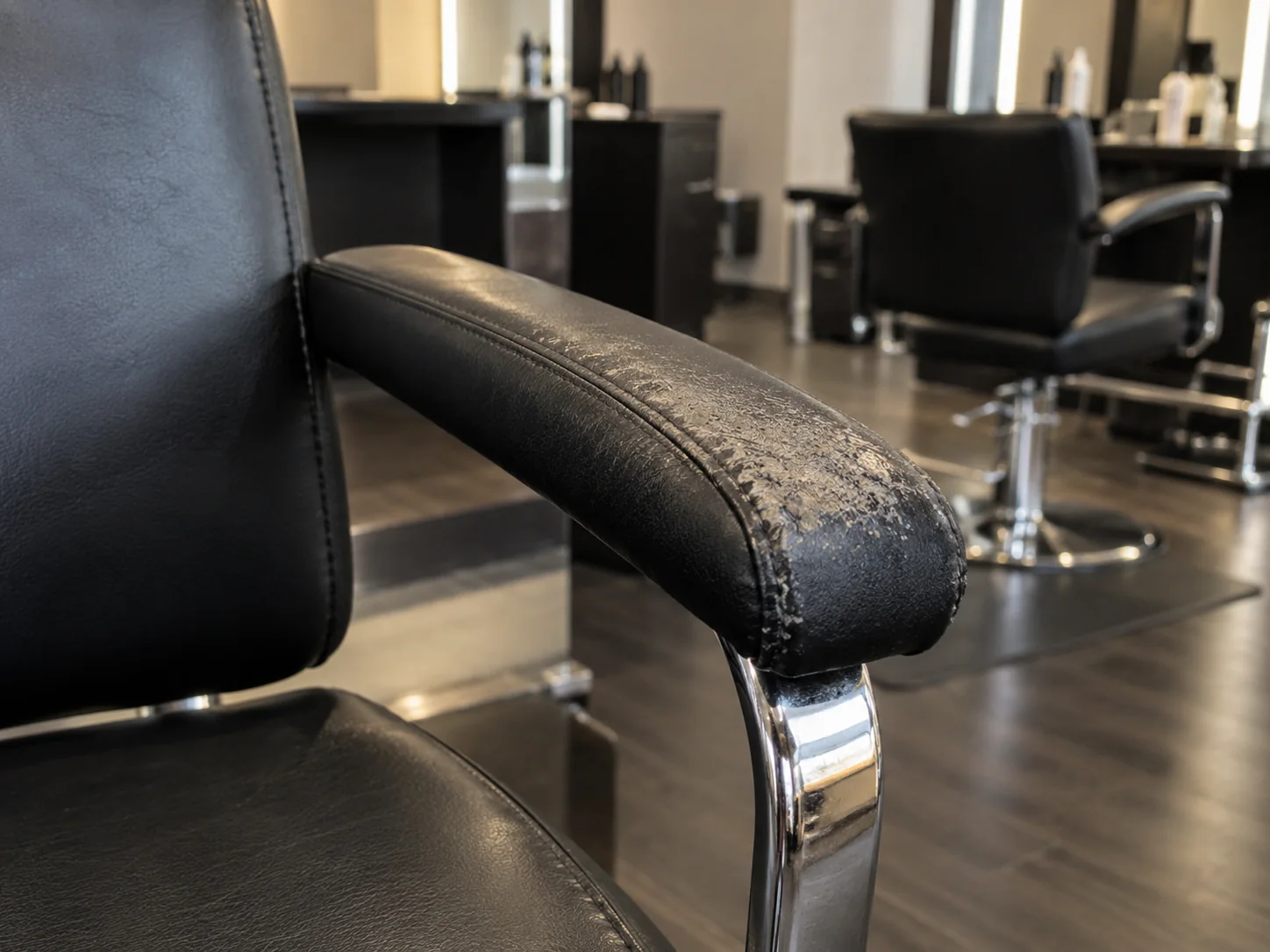 Worn finish on a salon chair armrest pad