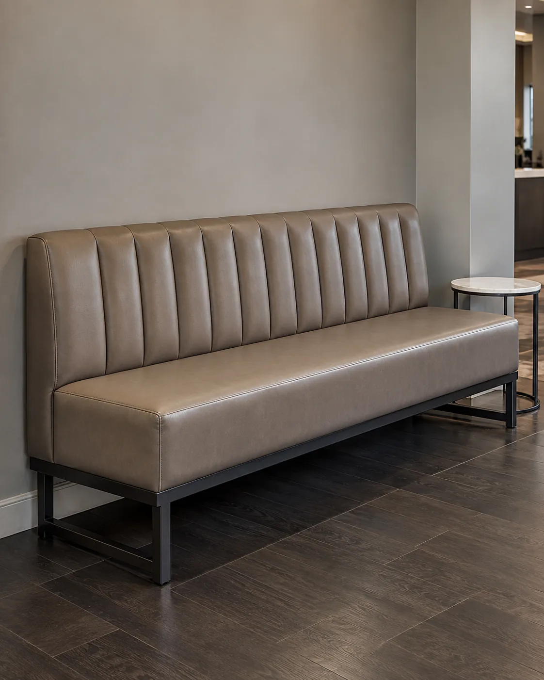 A channel-tufted taupe bench in a salon reception area