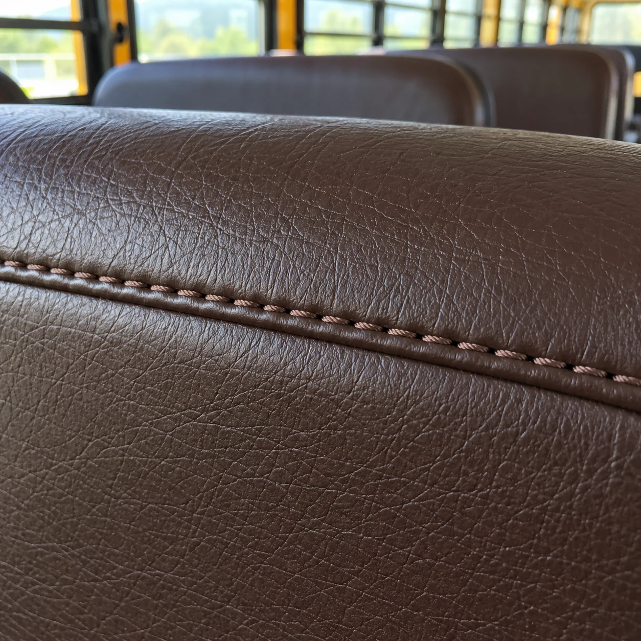 Macro of a school bus seat seam in heavy bonded thread