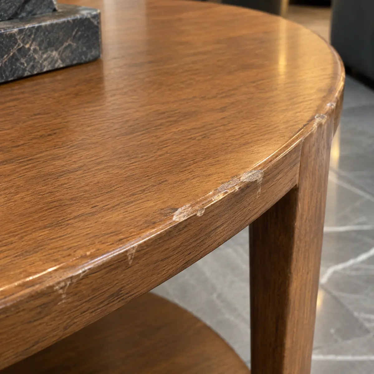 Scuffed edge on a round wood table