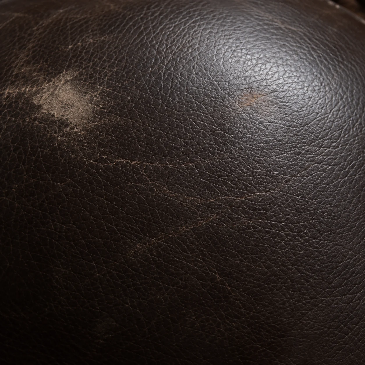 Abraded leather near a seam