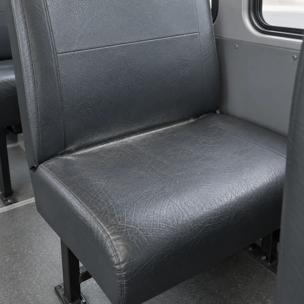 The back edge of a seat pressed down so the board line shows through the cover