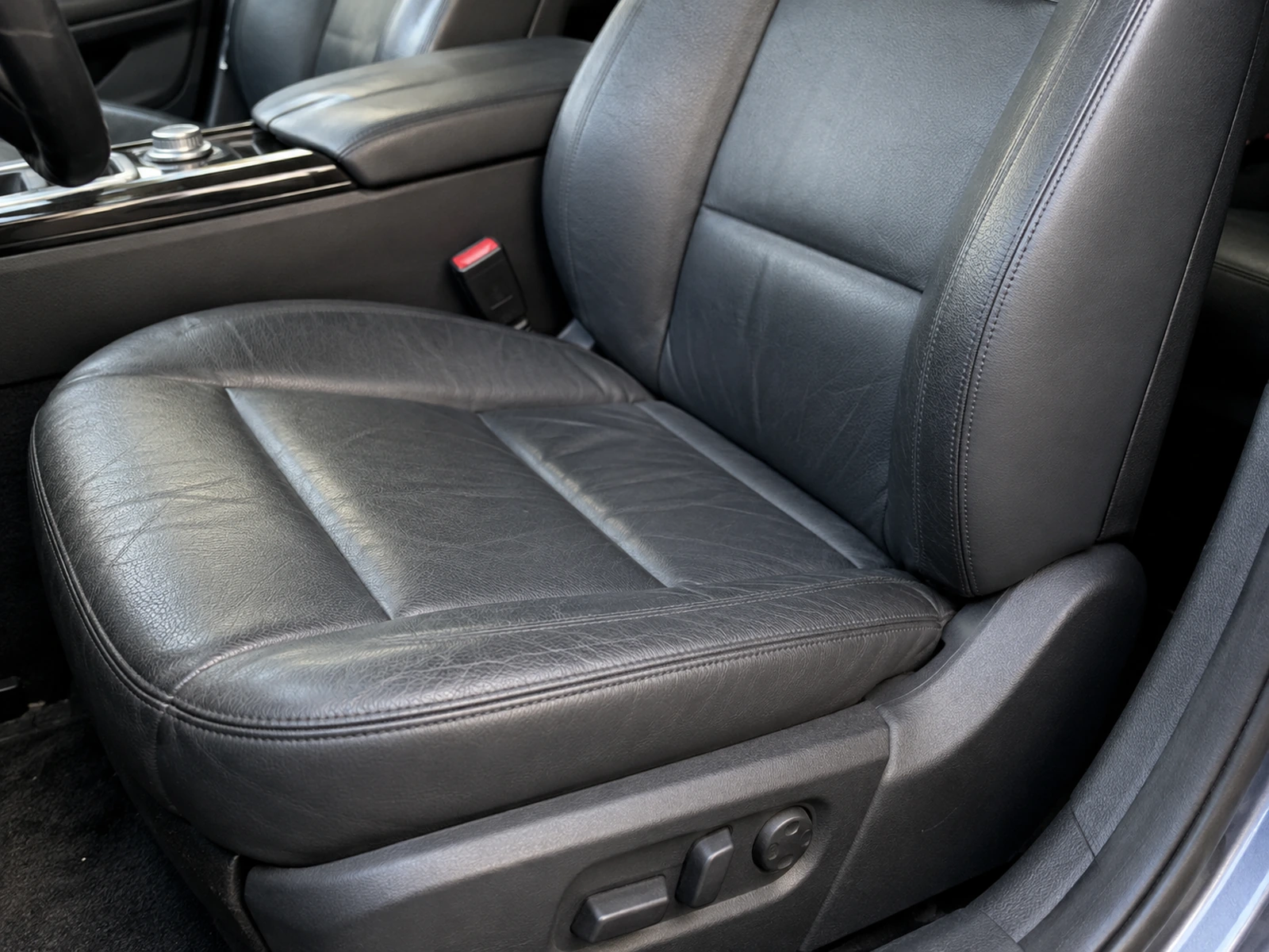 A vehicle seat with one replaced panel blended into the rest