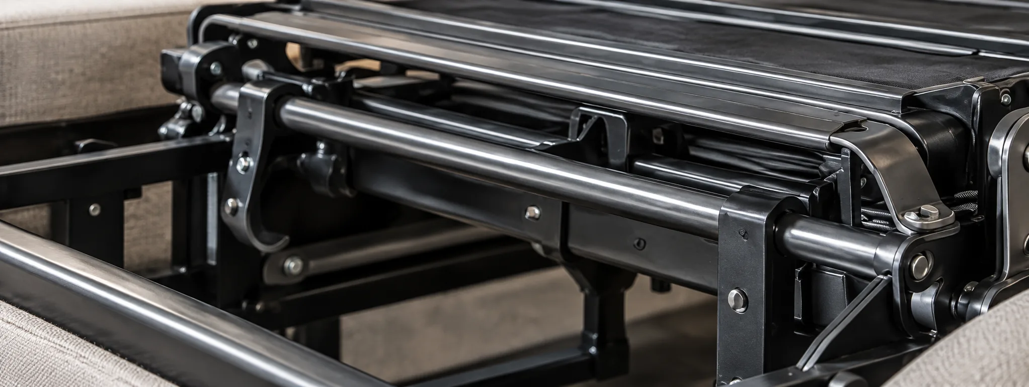 The black steel bar mechanism of a pull-out sleeper sofa, opened wide