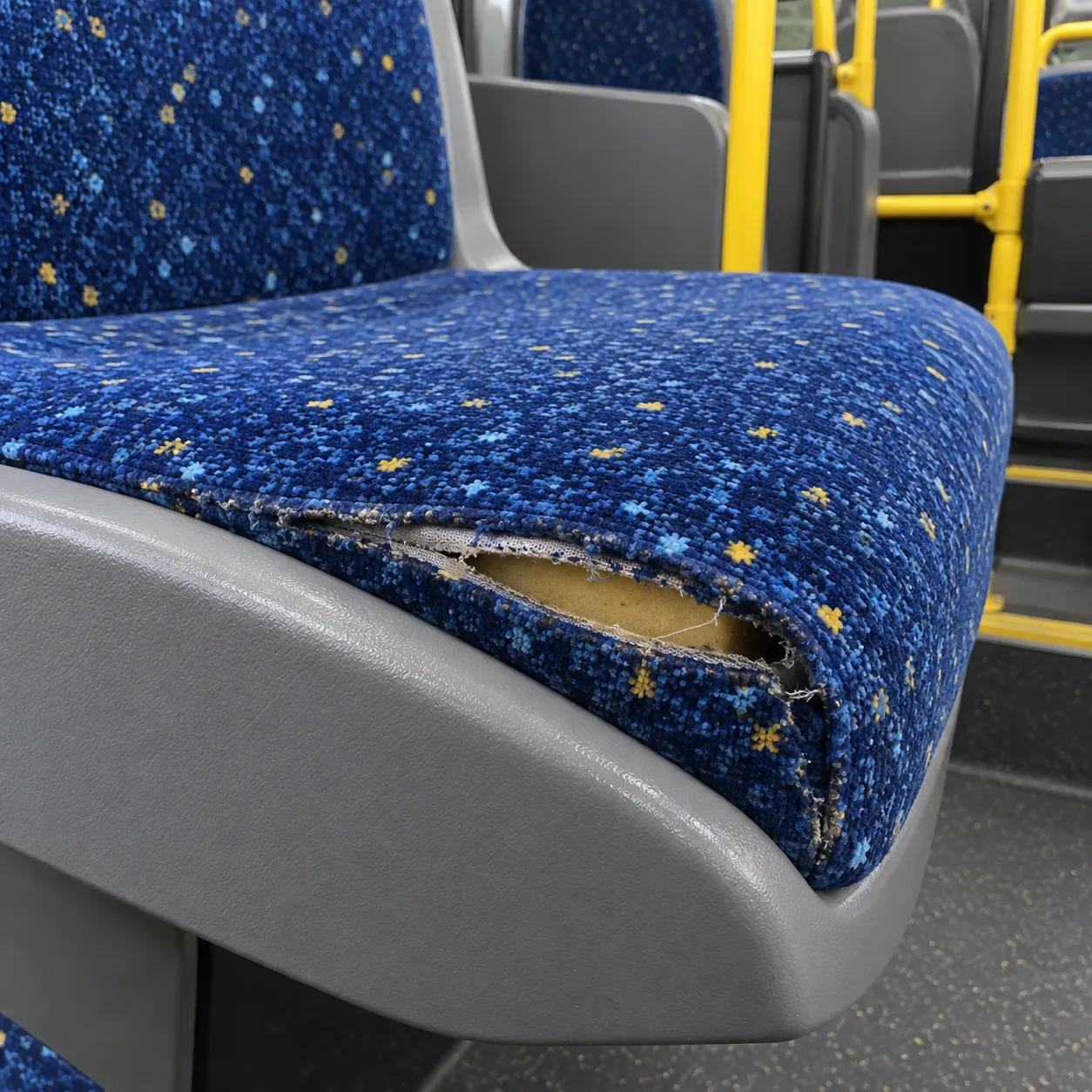 A split seam along the edge of a bus seat cushion