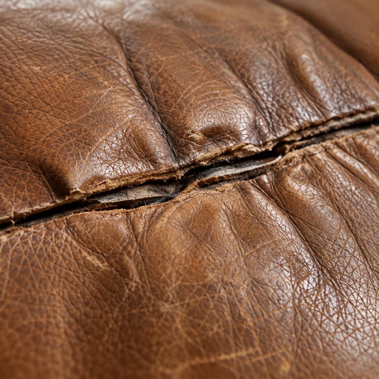 Split seam on a leather sectional cushion