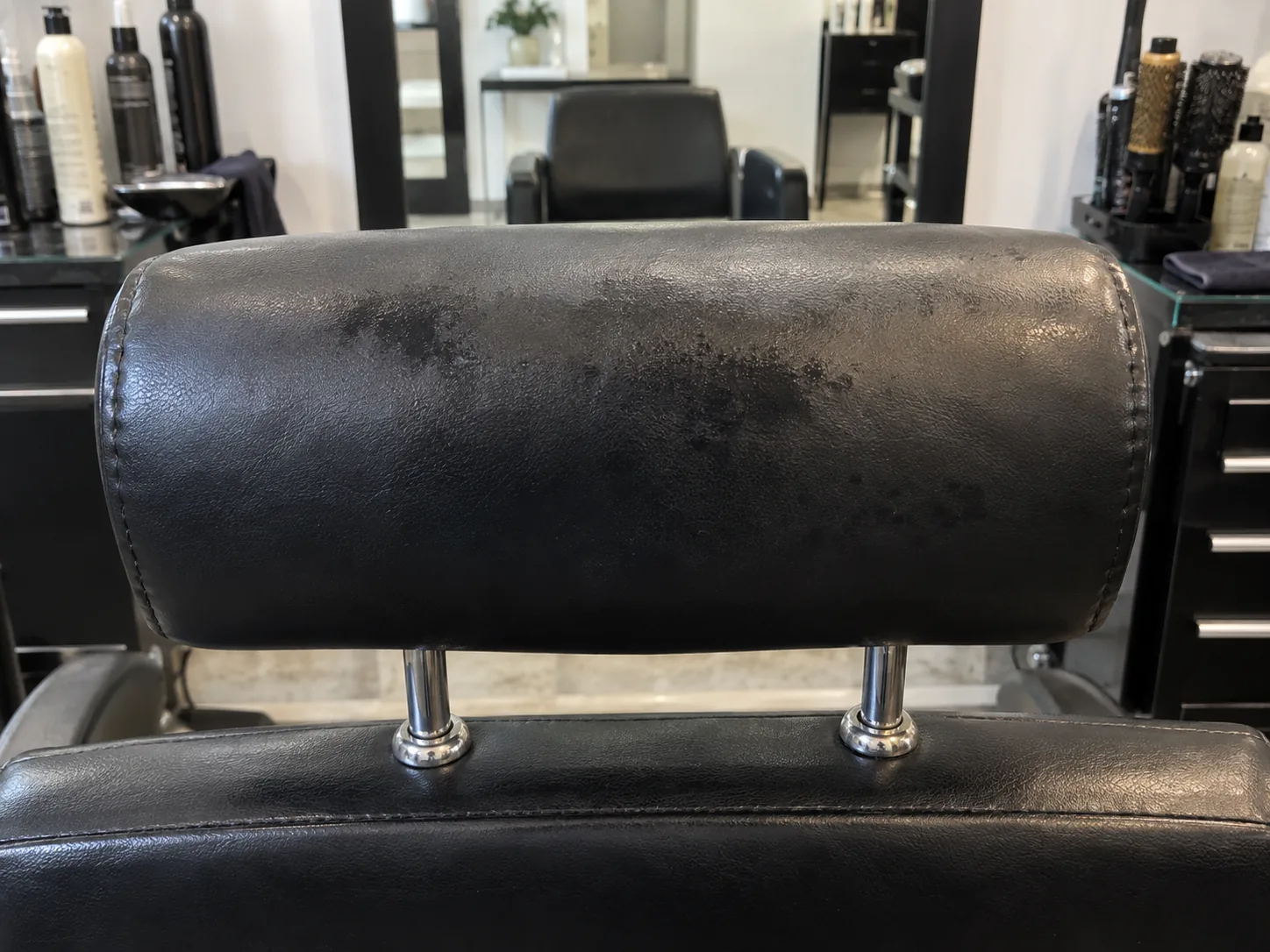 A stained styling chair headrest before reupholstery