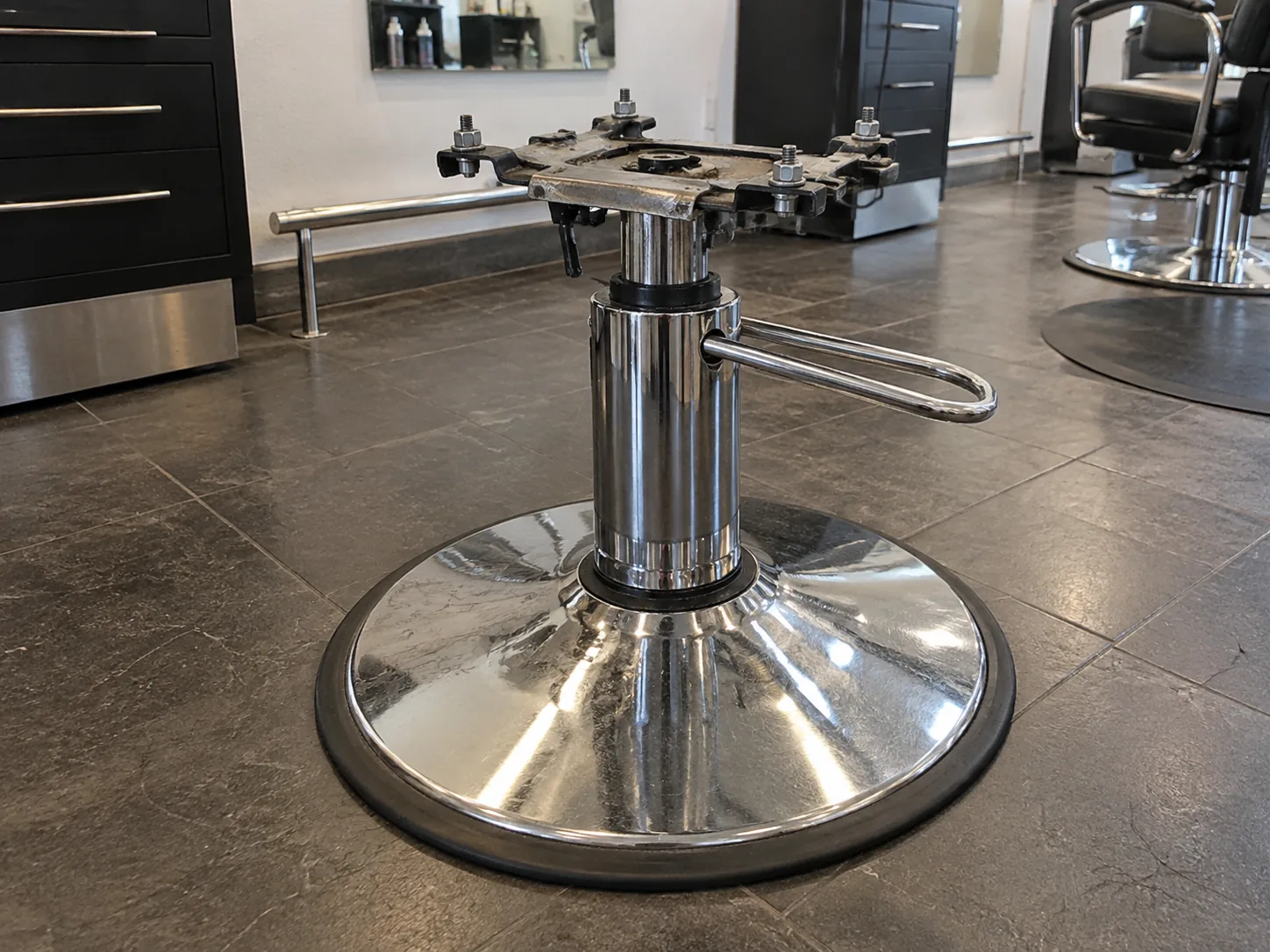 The hydraulic pump and base of a styling chair