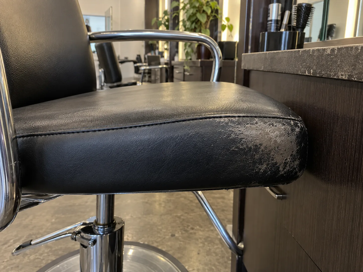 Rubbed vinyl on the side of a styling chair seat
