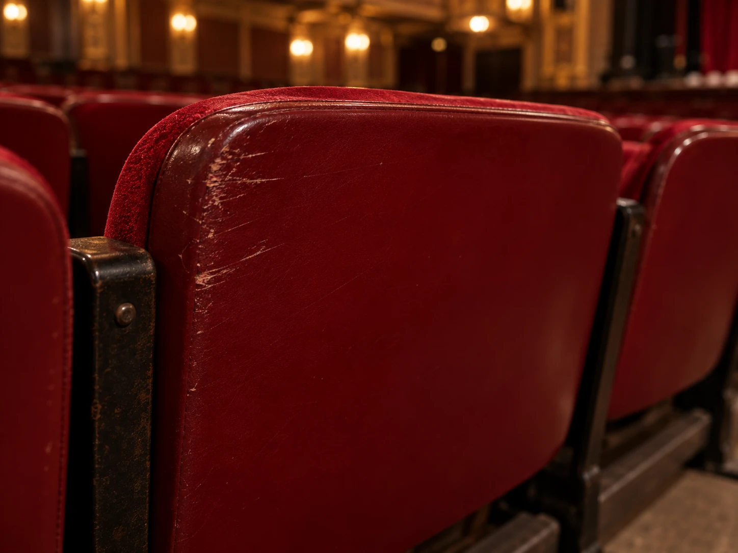 A scuffed back panel on a theater seat
