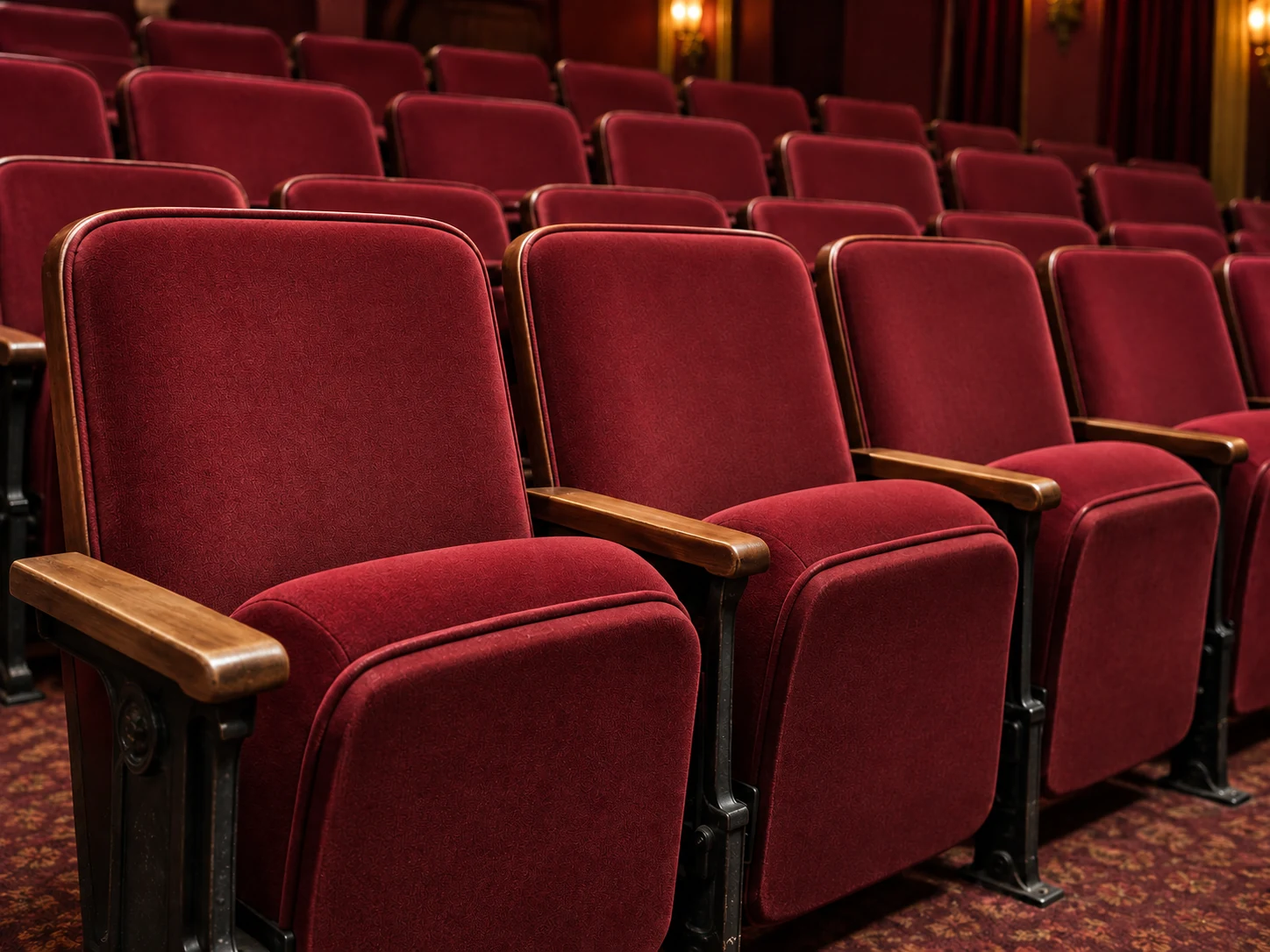 After: the same theater seats recovered in deep red velvet