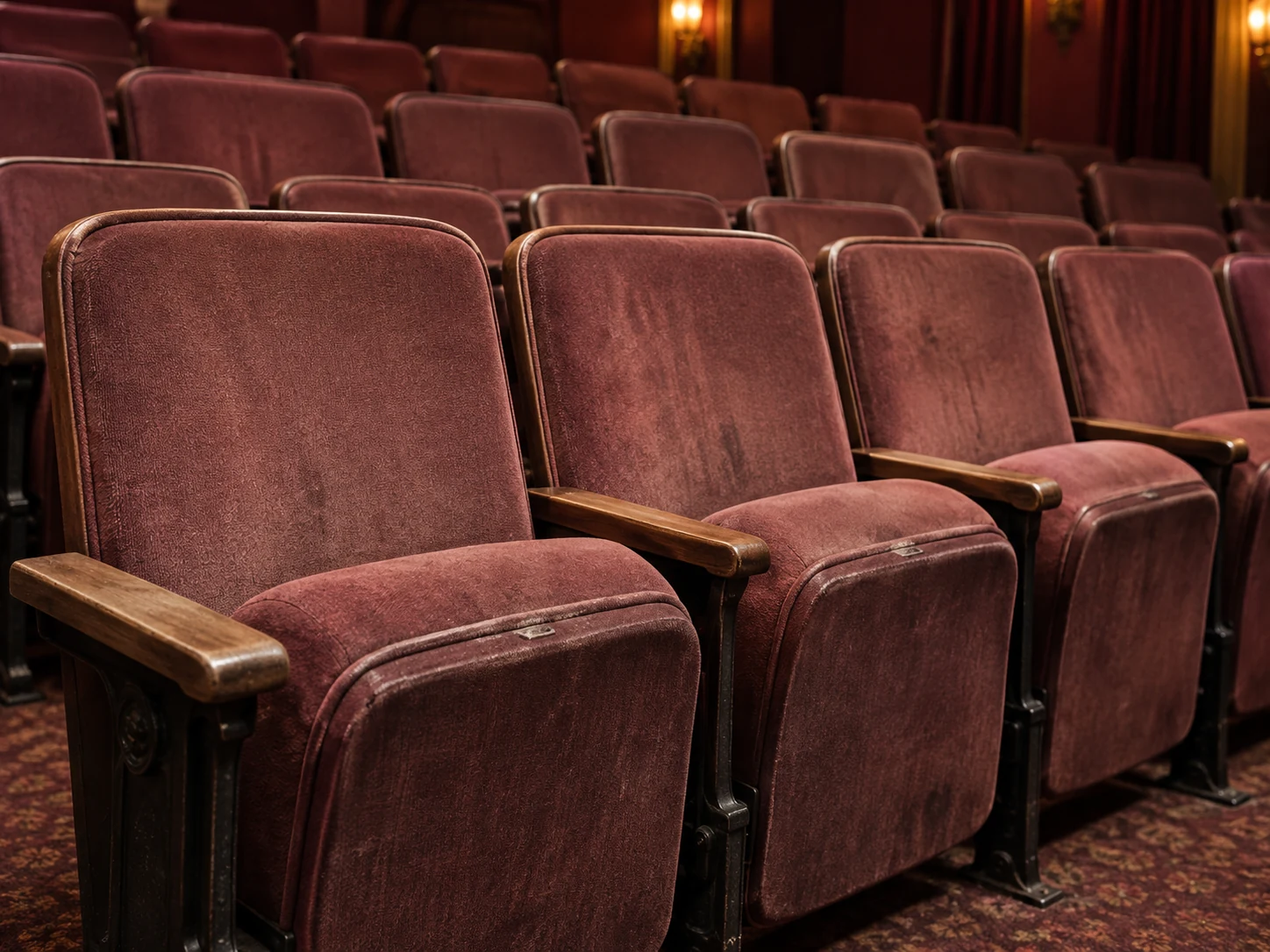 Before: faded and worn red velvet theater seats in a row
