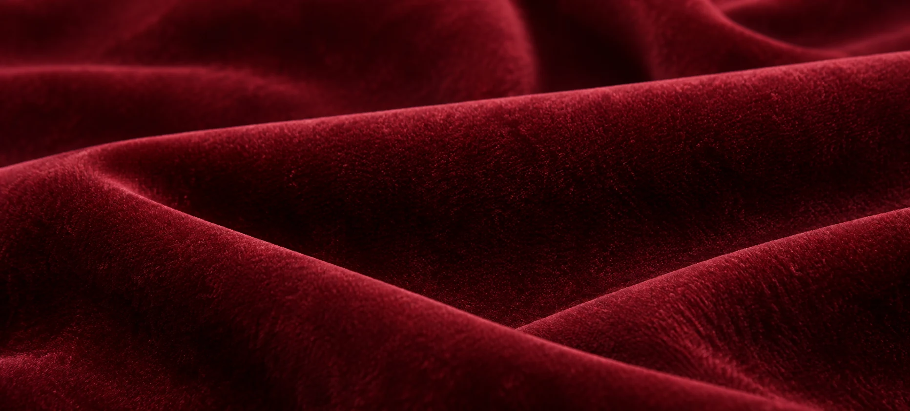 Deep red theater velvet swatch draped to show the pile