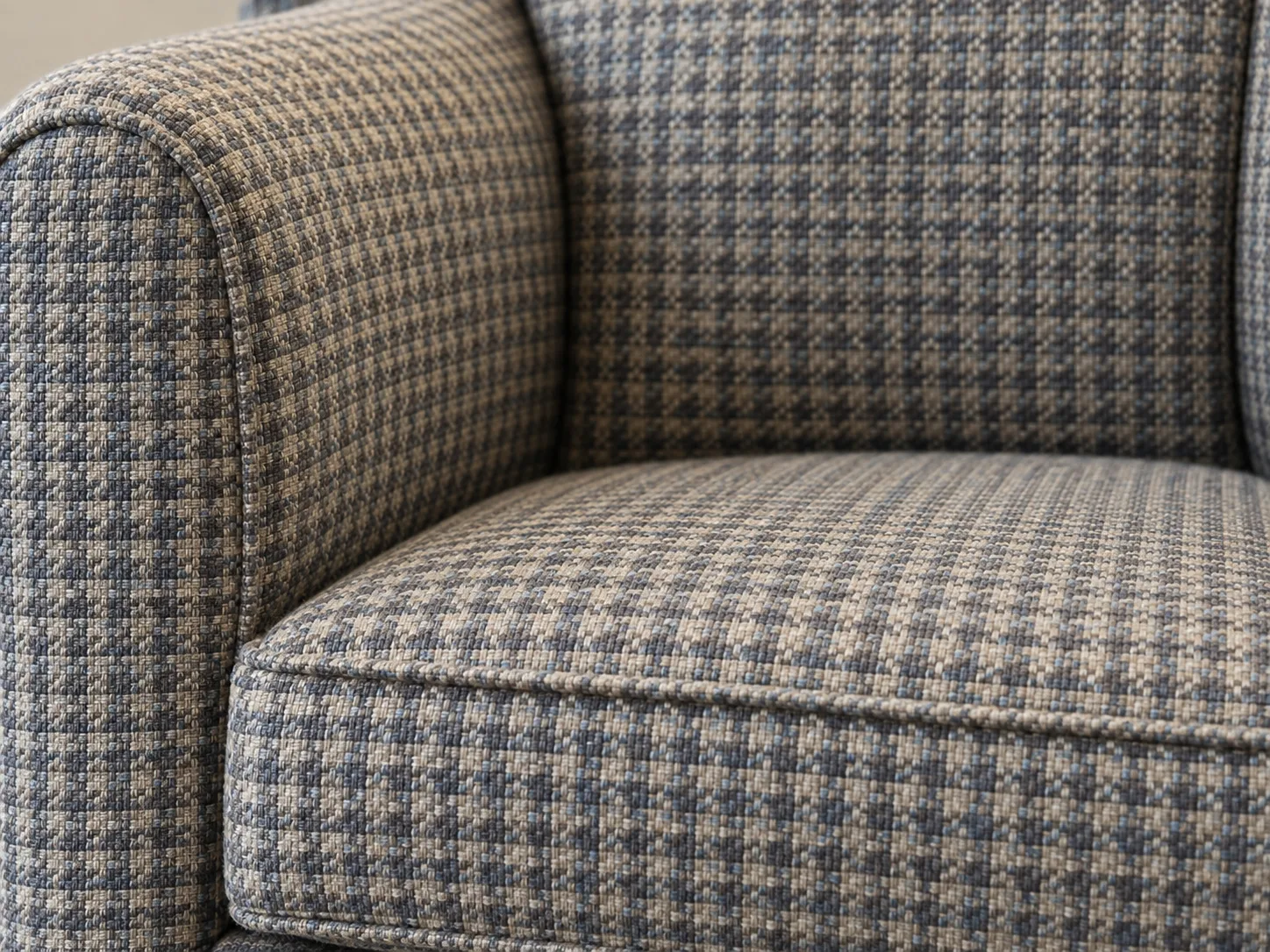 Houndstooth upholstery fabric showing surface wear on a chair