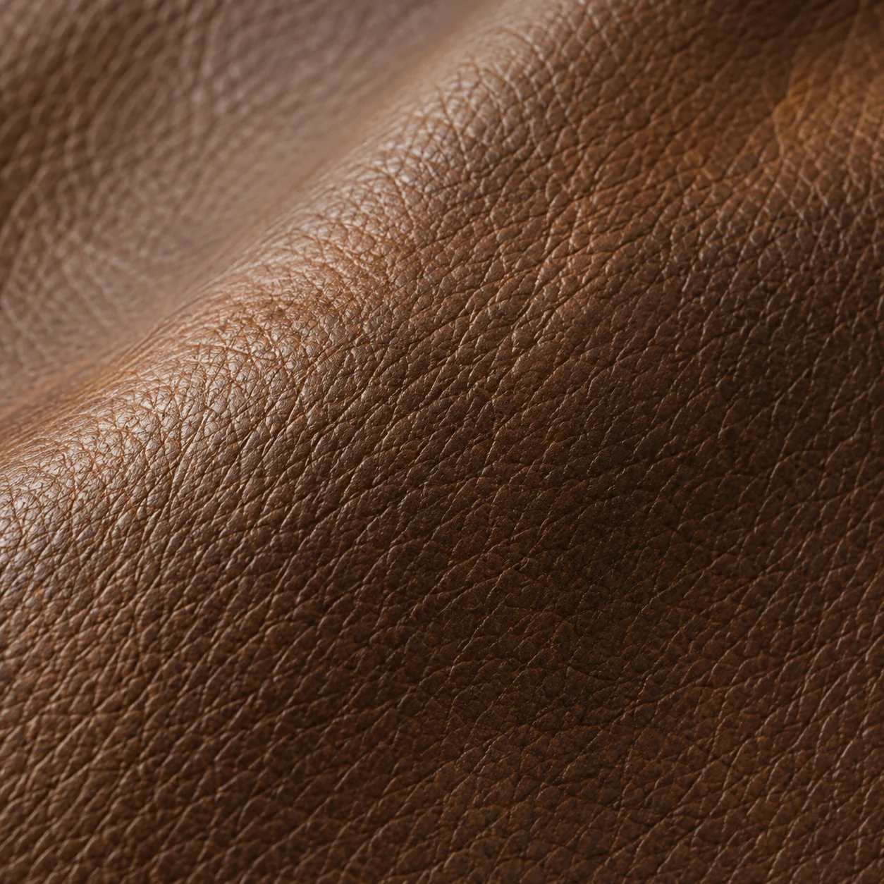 Aniline leather swatch in cognac showing open grain