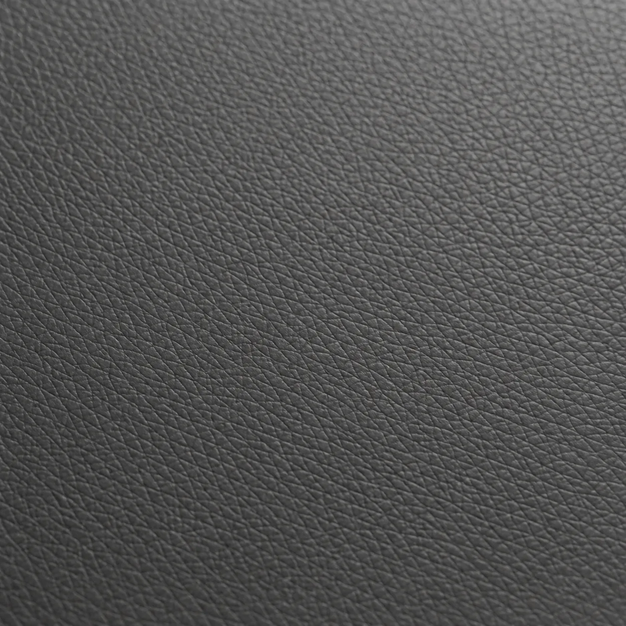 Close view of a restored charcoal vinyl seat surface