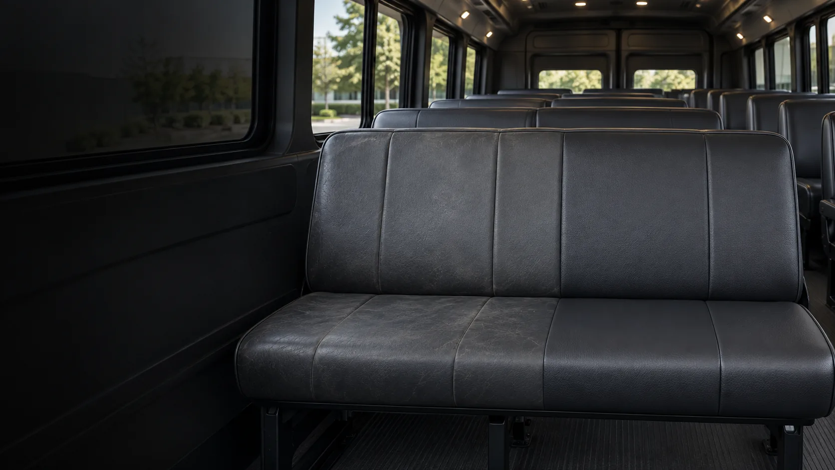 Vinyl seat repair NYC: a dark vinyl bench seat half worn and half freshly recolored