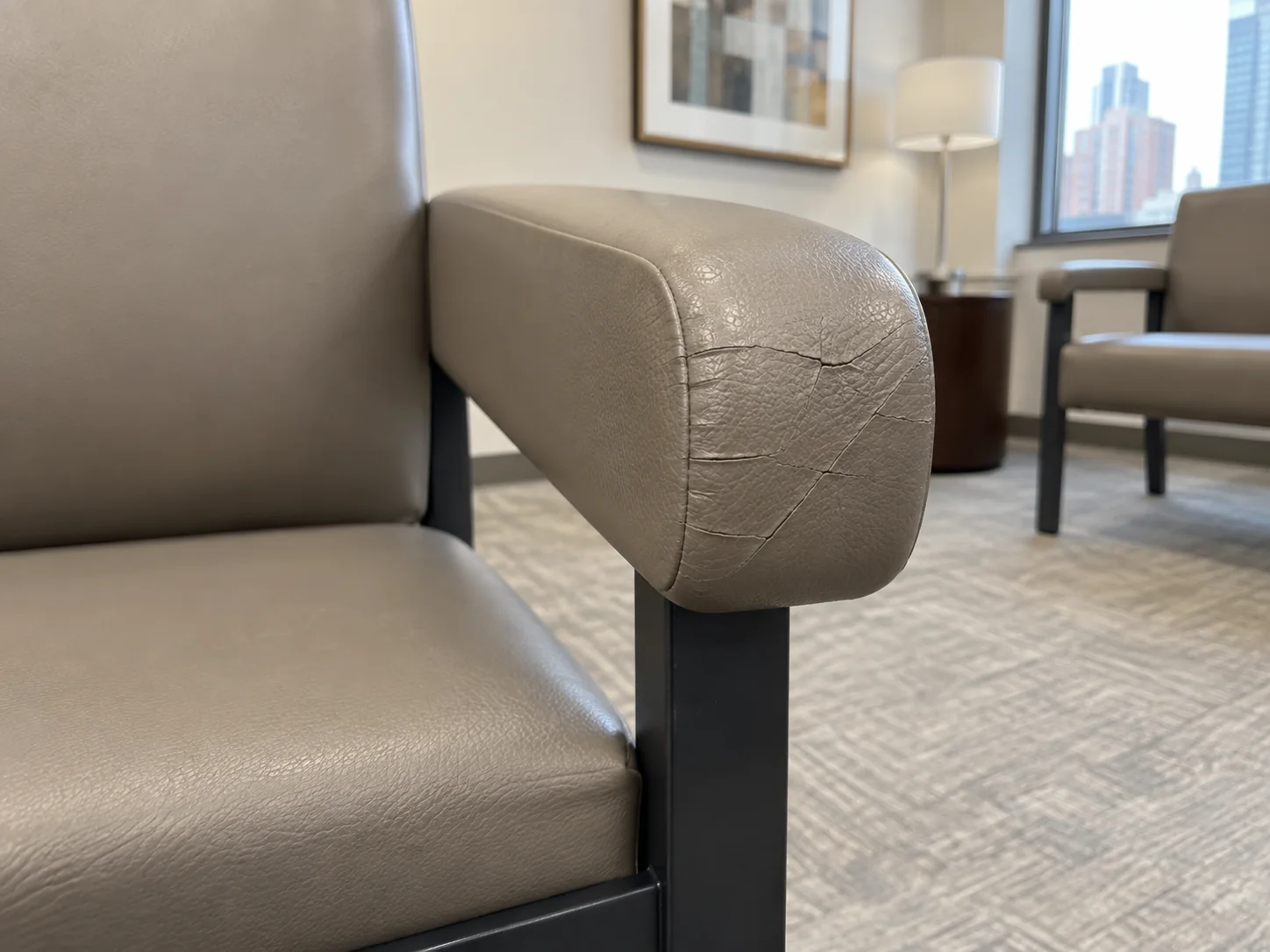 Before: cracked taupe vinyl on the front of a waiting room chair arm
