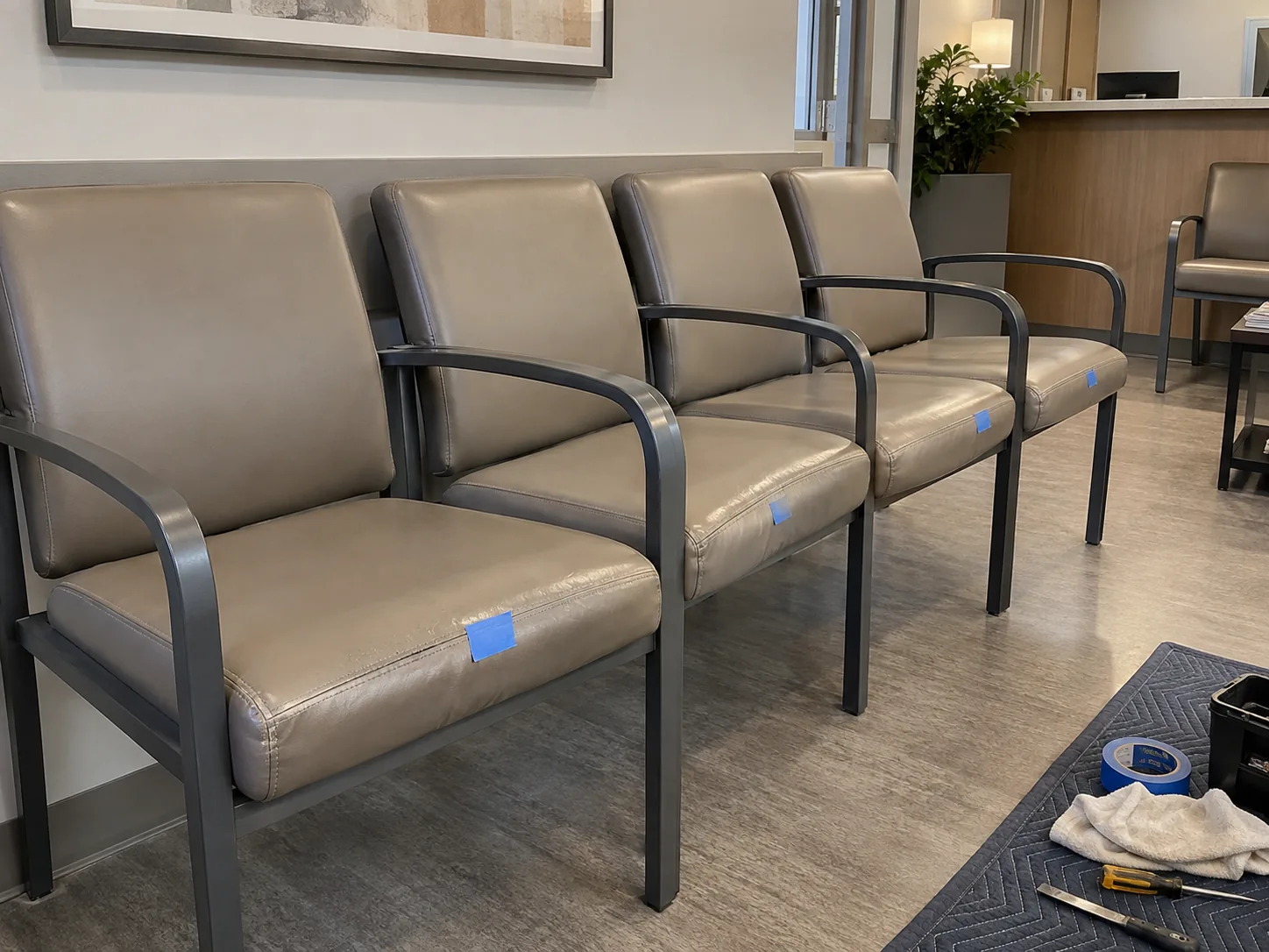 Waiting room chairs tagged with blue tape for reupholstery
