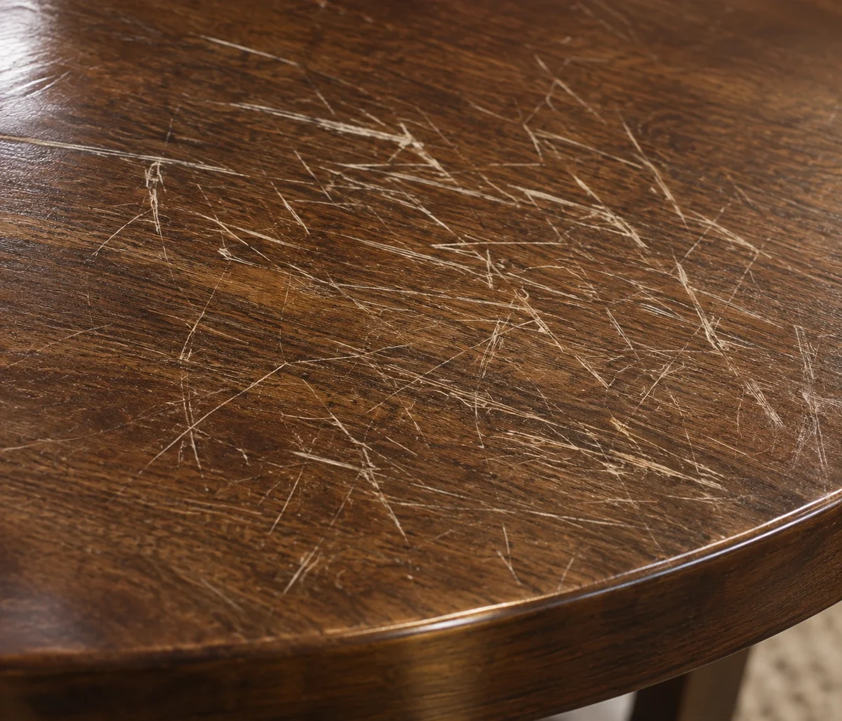 Scratches across a wood dining table top