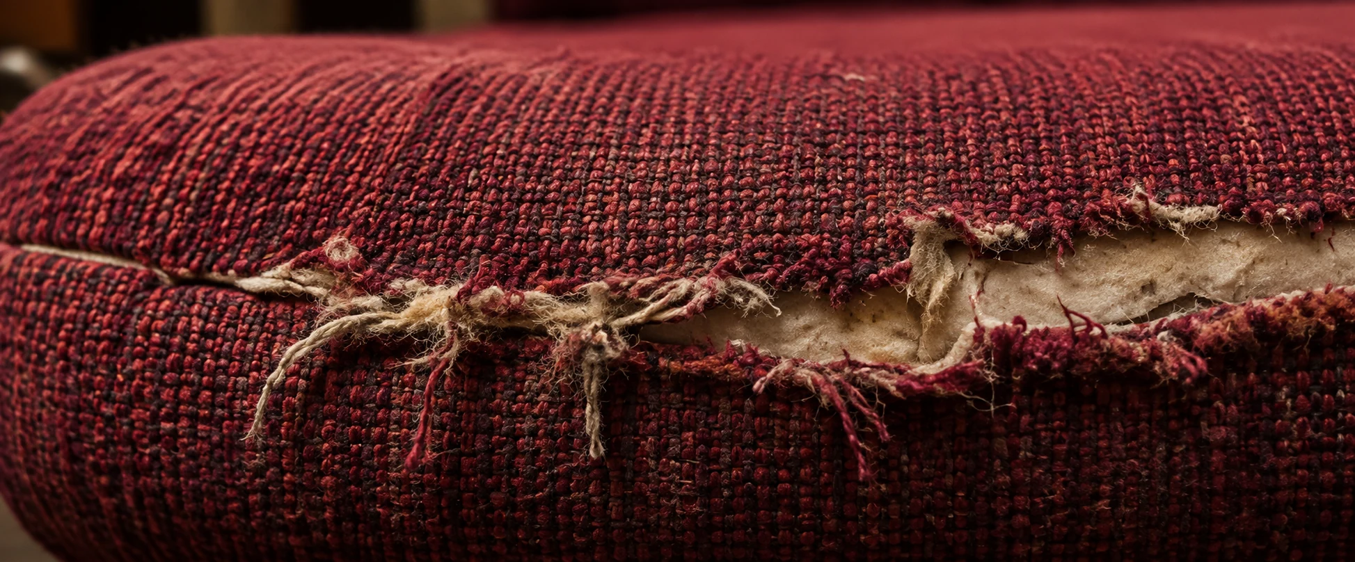 Frayed and worn front edge on an auditorium seat cover