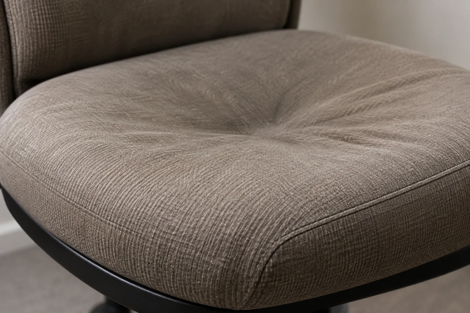 Taupe fabric seat cushion flattened and dished around the button