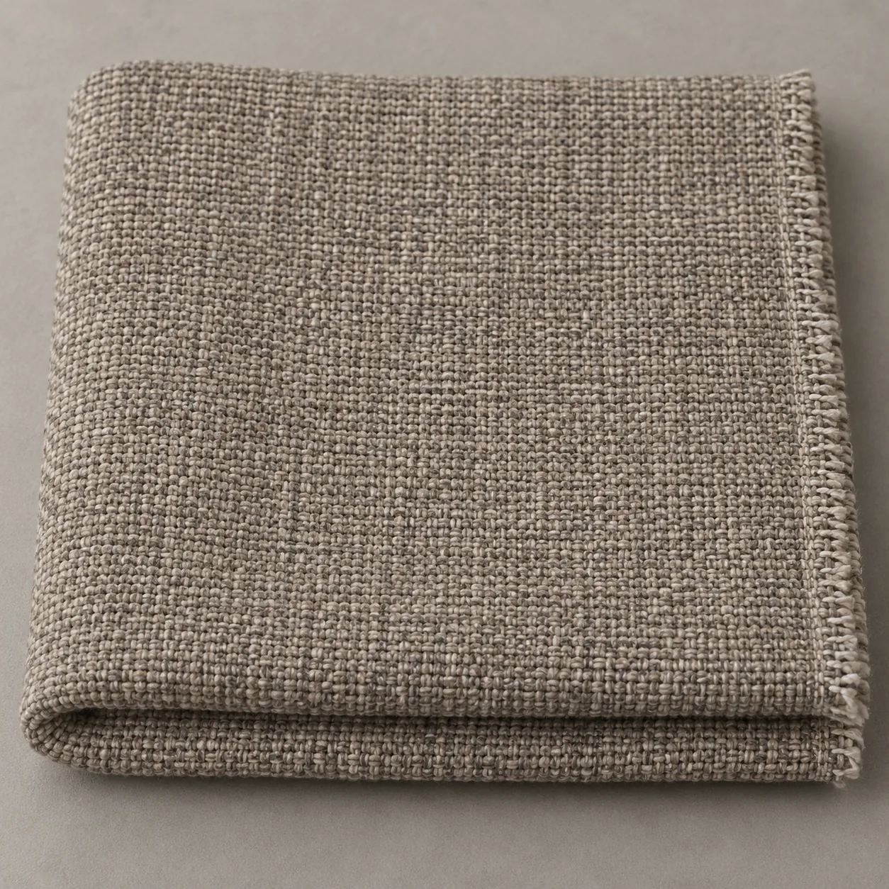 A swatch of taupe woven upholstery fabric