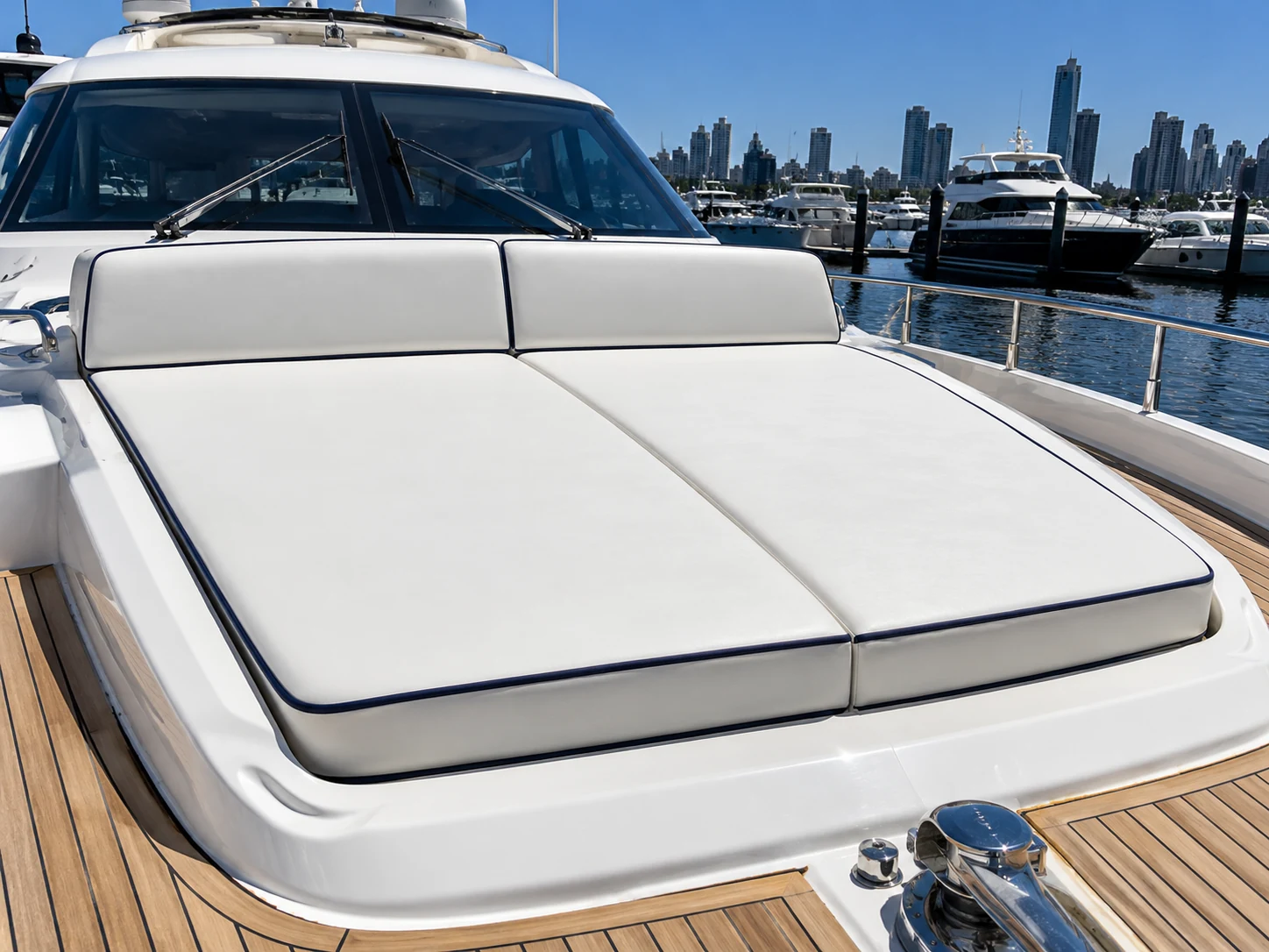 Close view of a sunlit yacht sun pad with navy piping